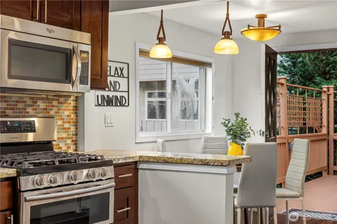 a kitchen with a stove a sink and a microwave