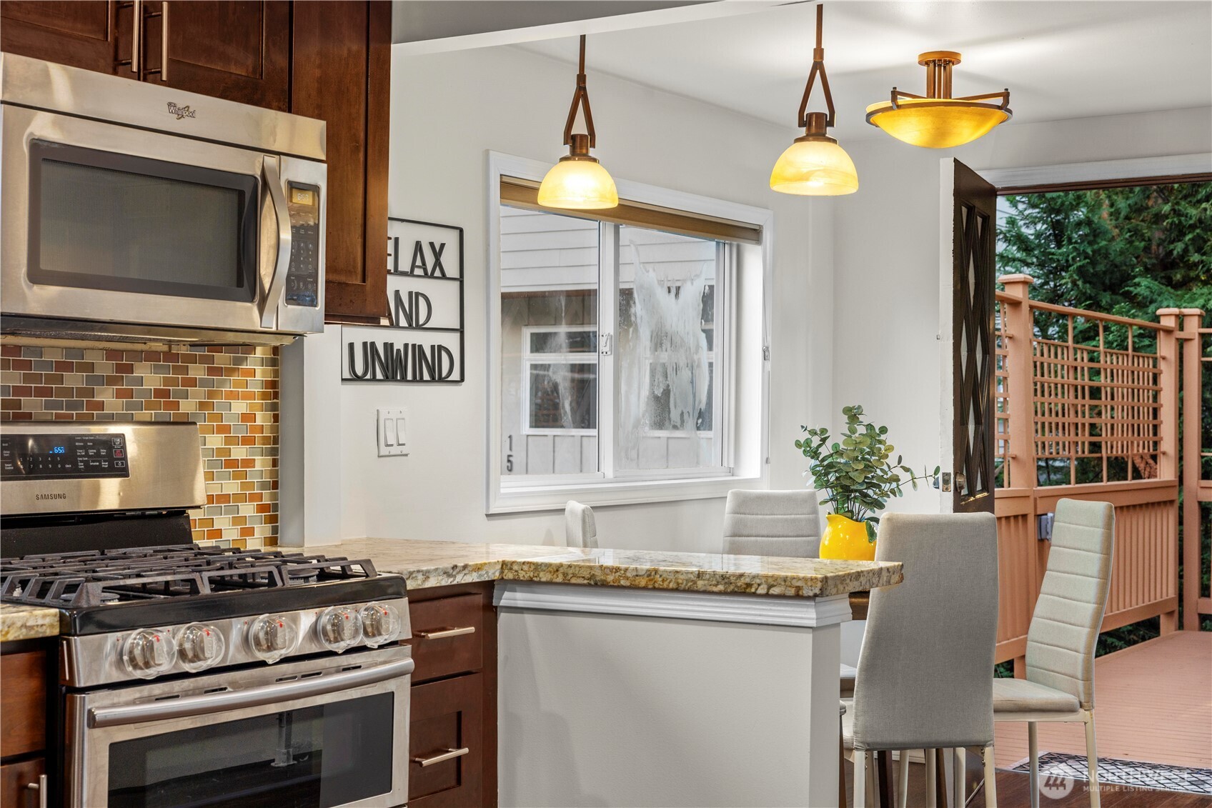 15245 Fremont Avenue North Shoreline, WA 98133 - Photo 9 of 28 a kitchen with a stove a sink and a microwave