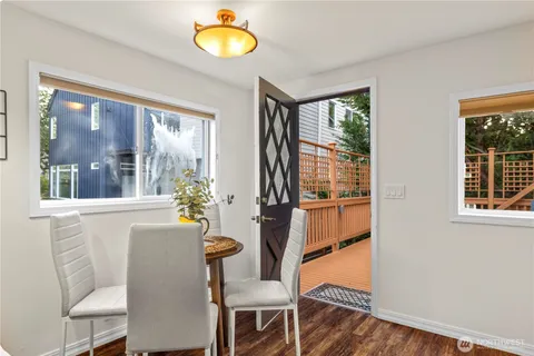 a dining room with furniture window and wooden floor