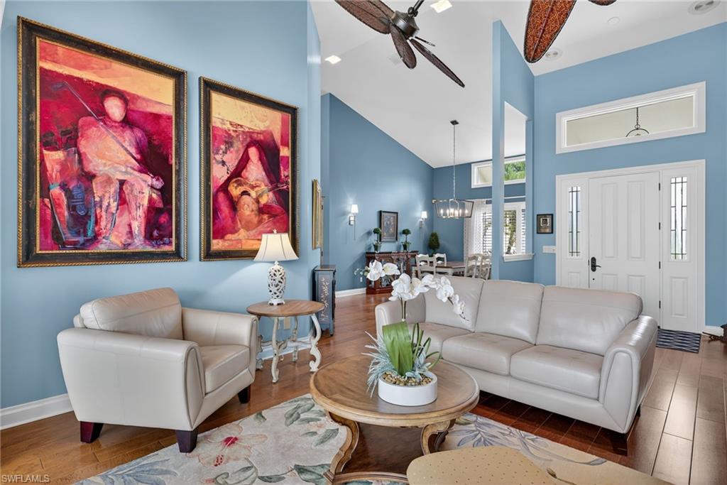 6 Bramblewood Point Naples, FL 34105 - Photo 11 of 47 a living room with furniture and a painting on the wall