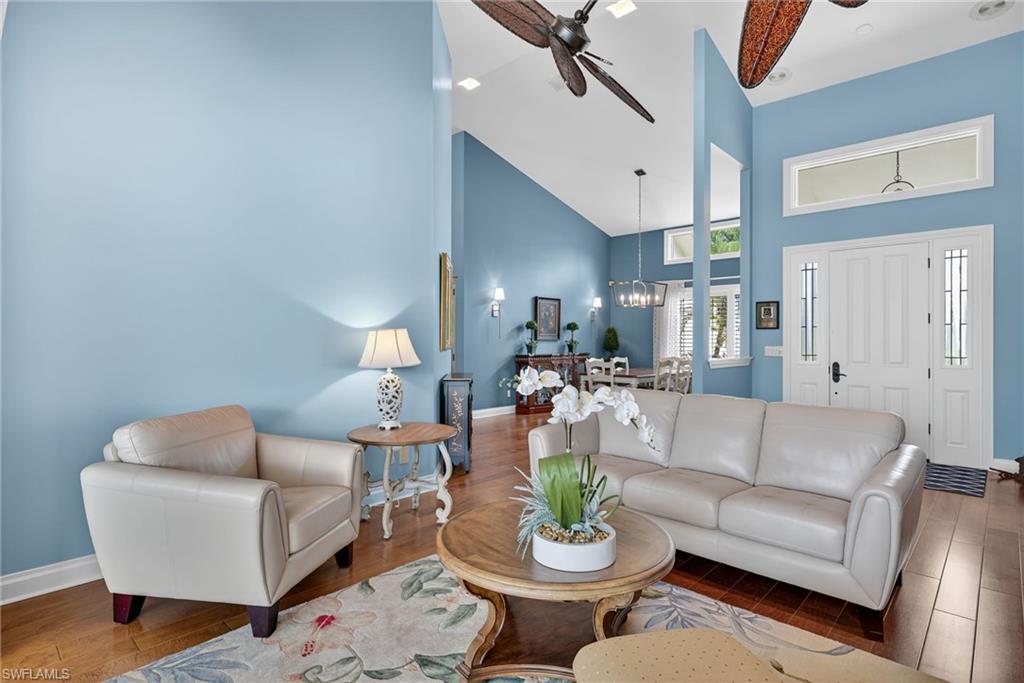 6 Bramblewood Point Naples, FL 34105 - Photo 12 of 47 a living room with furniture a rug and a chandelier