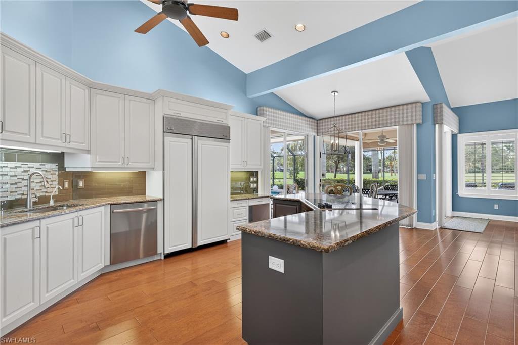 6 Bramblewood Point Naples, FL 34105 - Photo 14 of 47 a kitchen with counter top space and stainless steel appliances