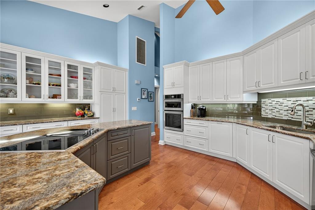 6 Bramblewood Point Naples, FL 34105 - Photo 15 of 47 a kitchen with stainless steel appliances granite countertop a stove a sink and a refrigerator