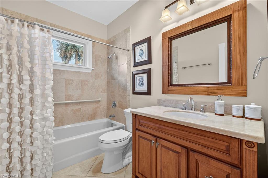 6 Bramblewood Point Naples, FL 34105 - Photo 26 of 47 a bathroom with a toilet a sink a bath tub and mirror