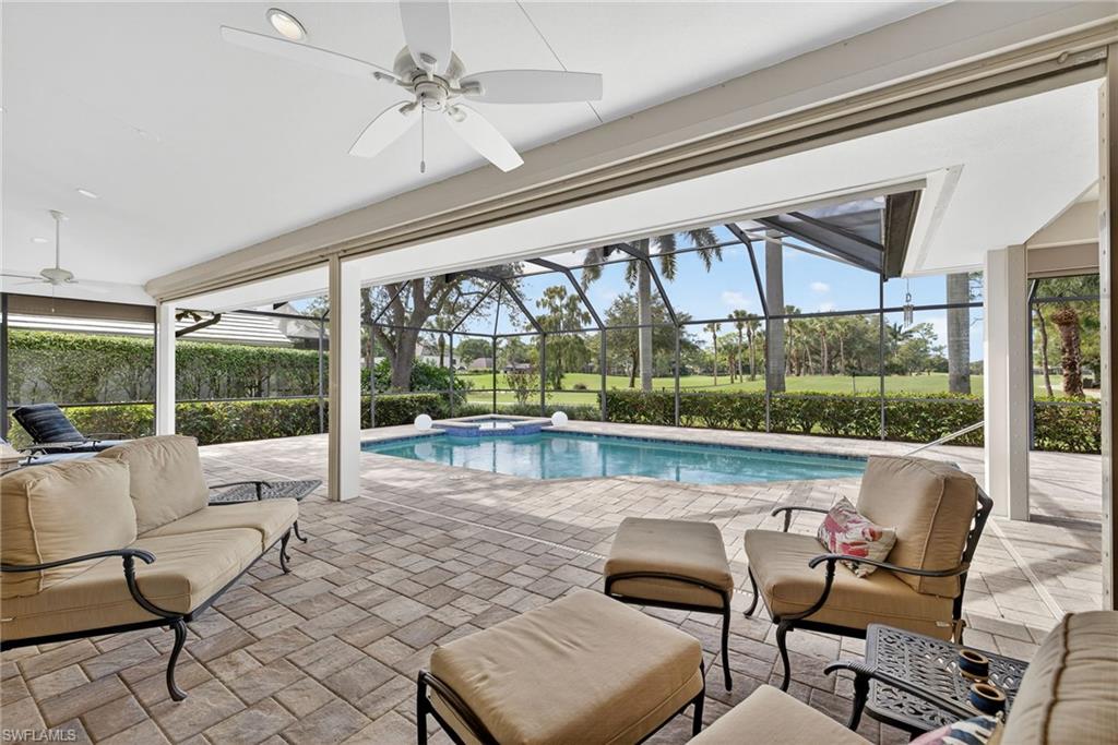 6 Bramblewood Point Naples, FL 34105 - Photo 32 of 47 a living room with furniture and a large window