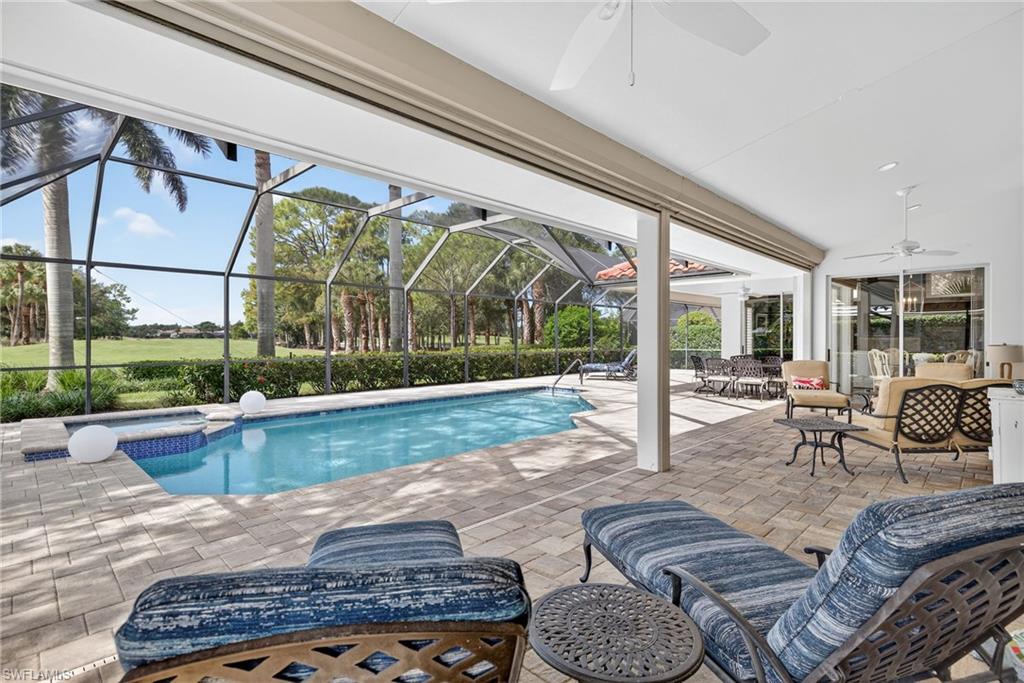 6 Bramblewood Point Naples, FL 34105 - Photo 33 of 47 a living room with furniture and a floor to ceiling window