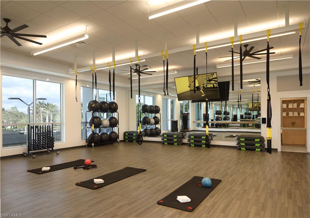 6 Bramblewood Point Naples, FL 34105 - Photo 45 of 47 a gym room with gym equipment and a large window