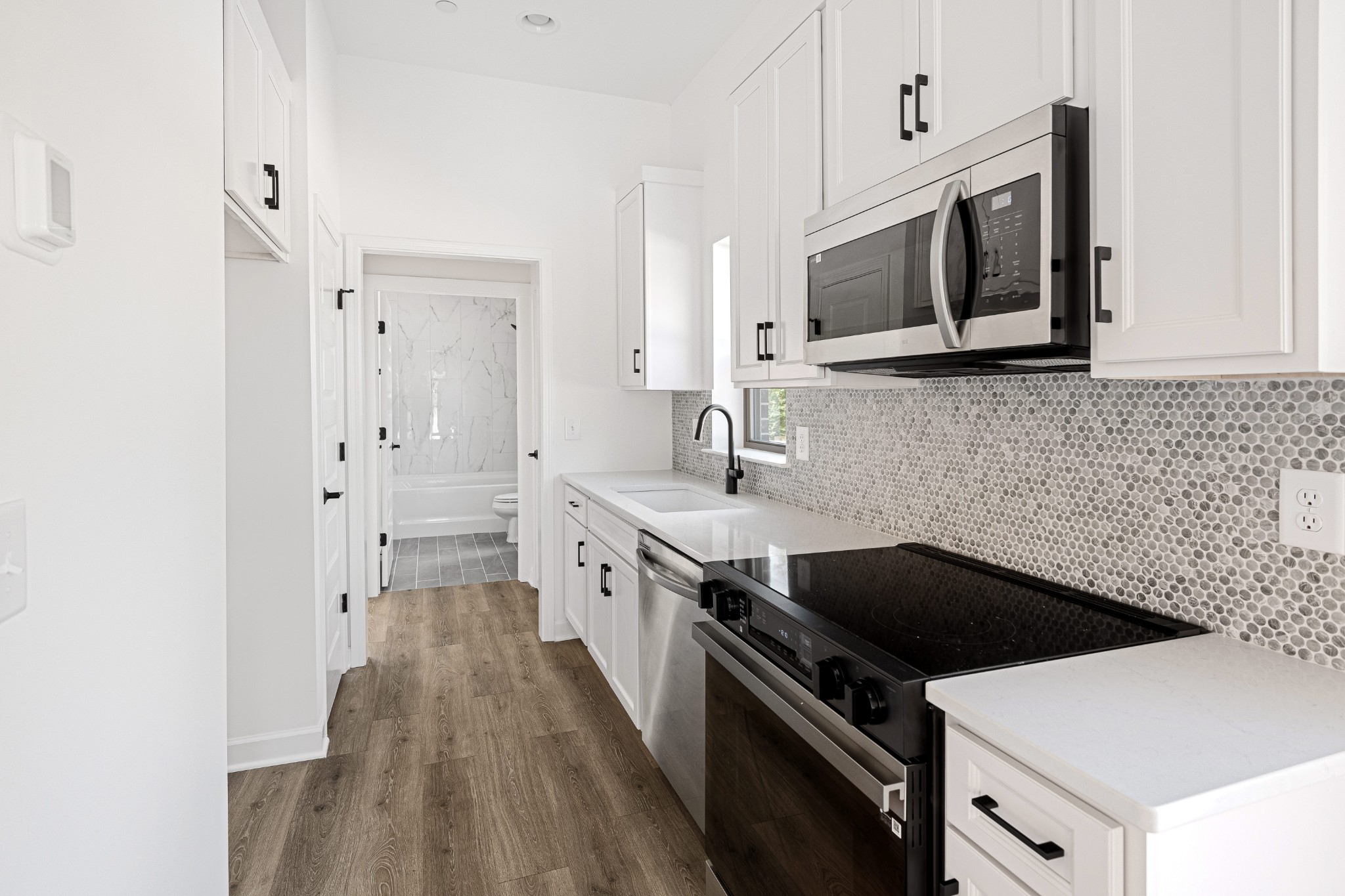 361 A Wellows Chase Spring Hill, TN 37174 - Photo 2 of 25 a kitchen with stainless steel appliances a stove microwave and cabinets