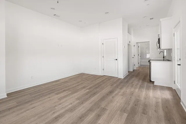 an empty room with a empty space and windows