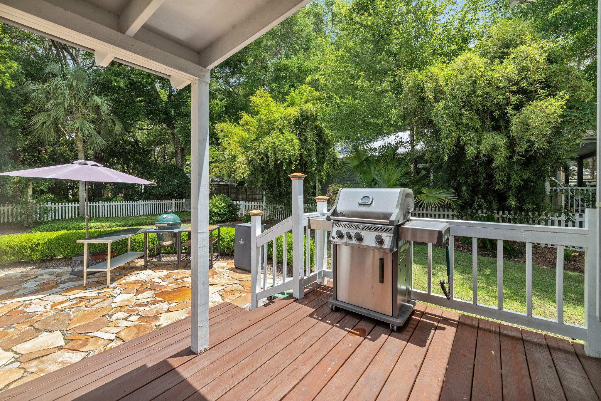 214 Chrysler Avenue Santa Rosa Beach, FL 32459 - Photo 29 of 53 a view of a deck with a table and chairs under an umbrella with wooden floor