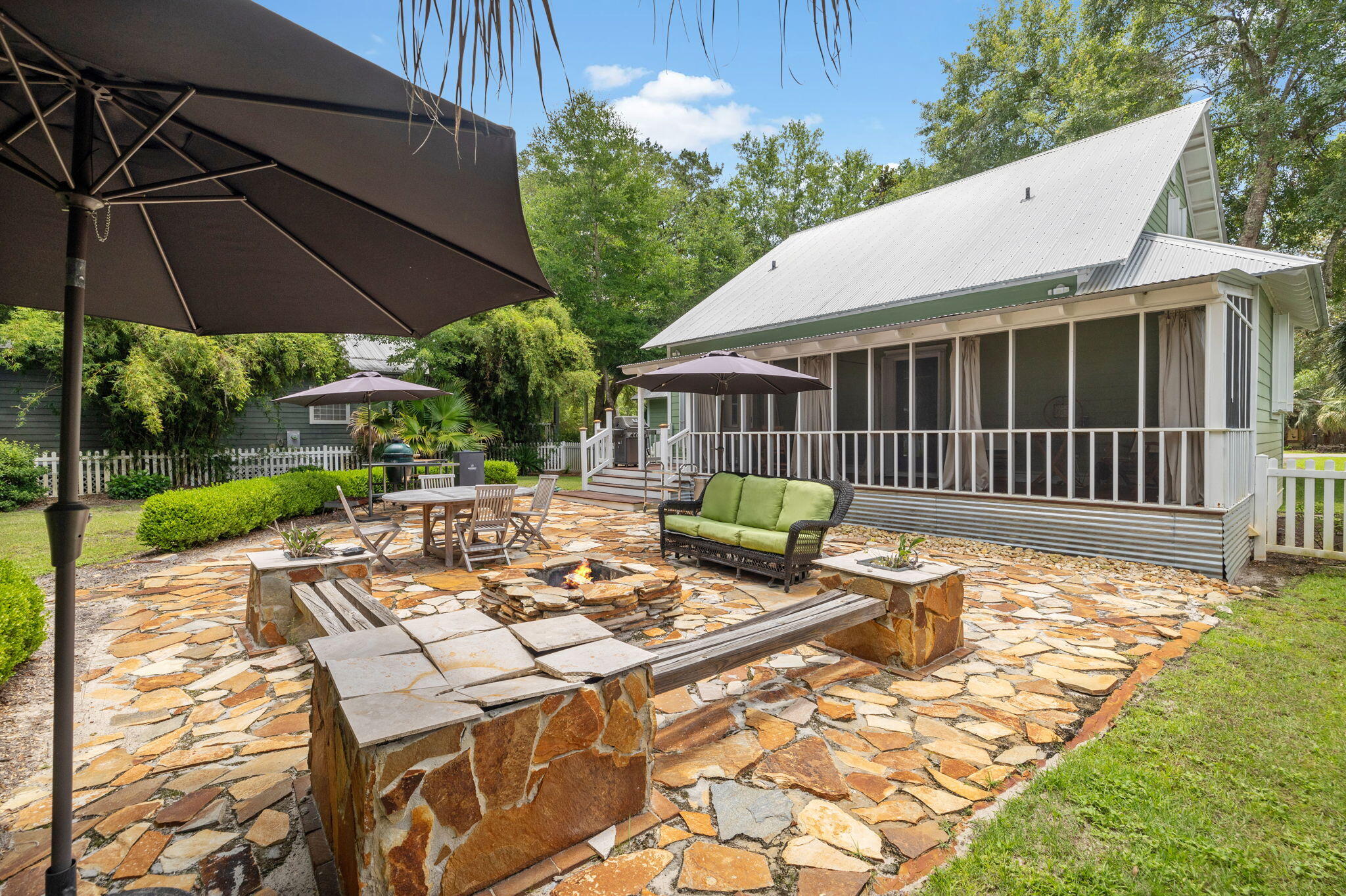 214 Chrysler Avenue Santa Rosa Beach, FL 32459 - Photo 4 of 53 a view of a patio with a table chairs and a yard