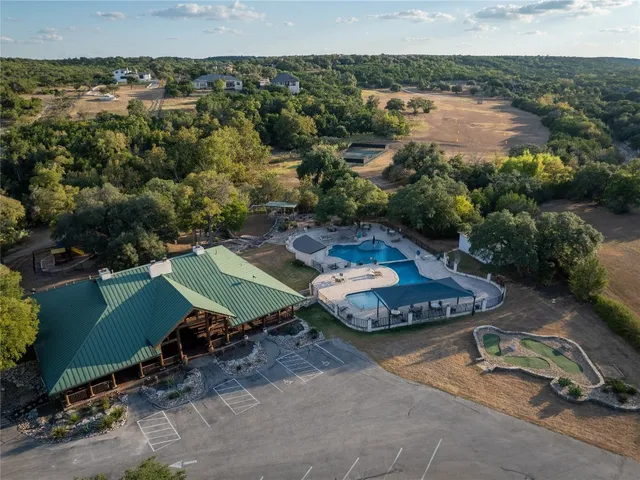 an aerial view of a house with a yard and lake view