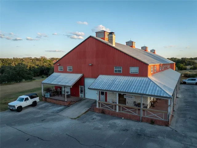 a view of a house with a yard and sitting area