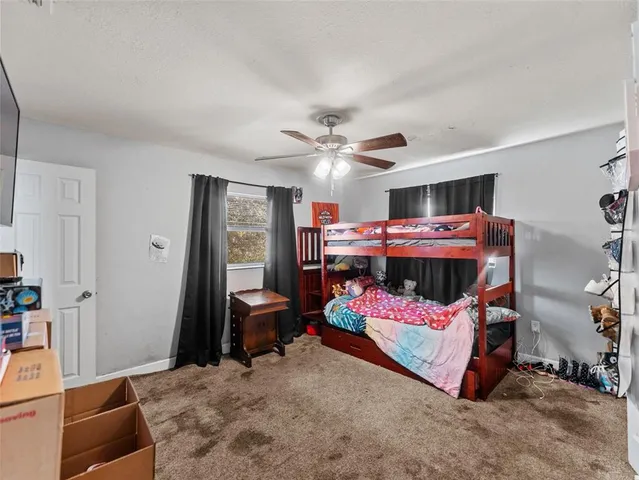 a bed room with a bed and a chair