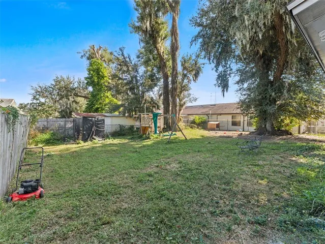a view of a house with a backyard