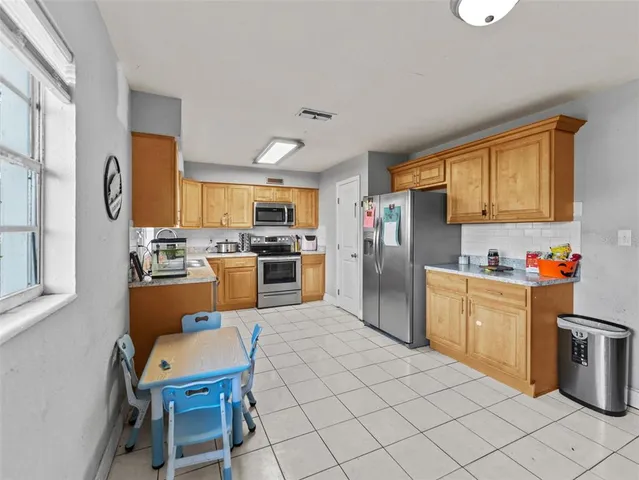 a kitchen with granite countertop appliances cabinets and furniture