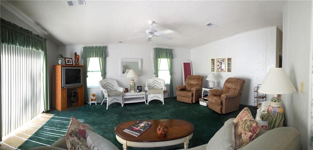 913 Manatee Road Naples, FL 34114 - Photo 3 of 13 a living room with furniture and a fireplace