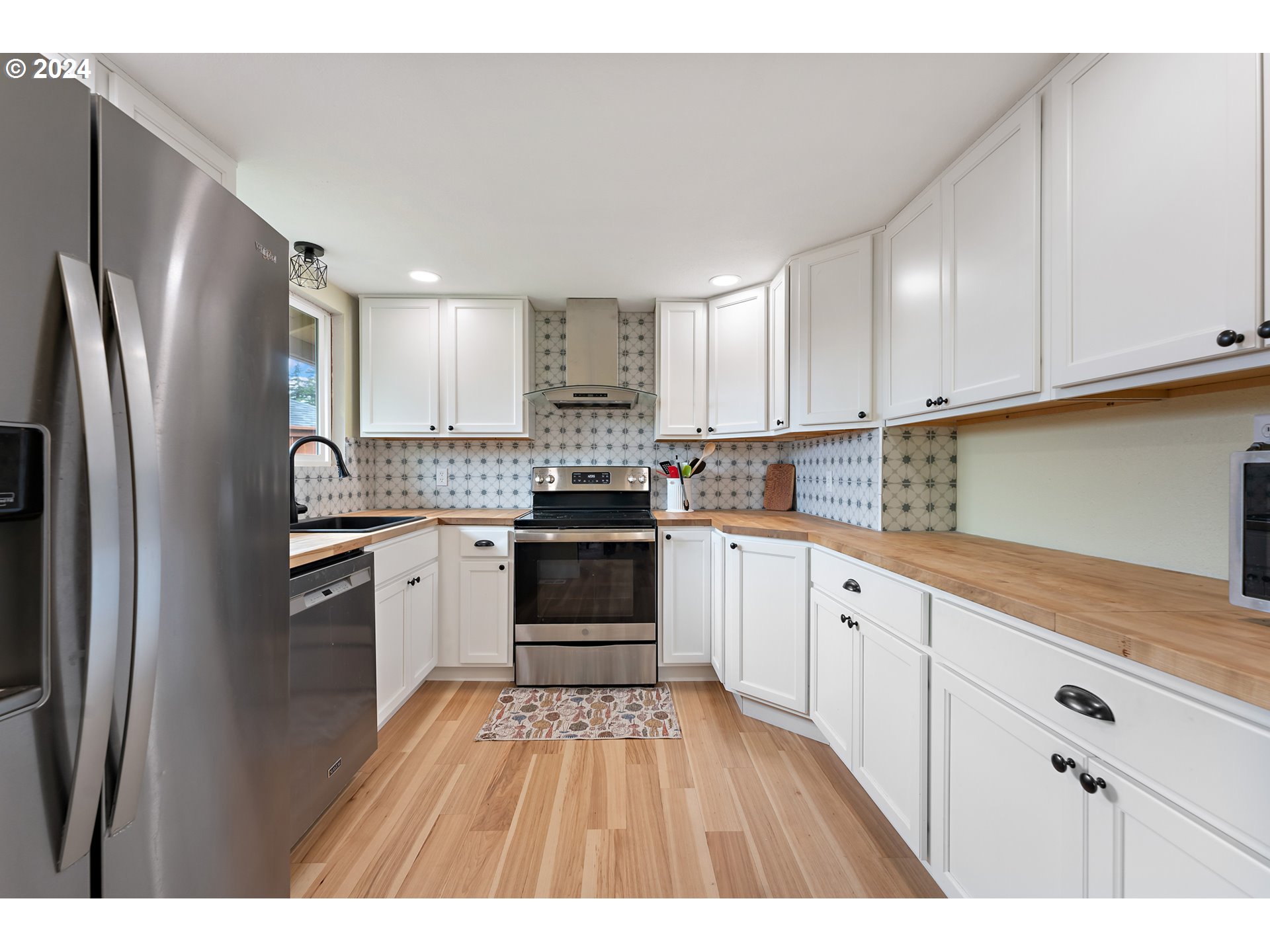 16540 Southwest Queen Mary Avenue Portland, OR 97224 - Photo 13 of 30 a kitchen with stainless steel appliances granite countertop a refrigerator sink and cabinets