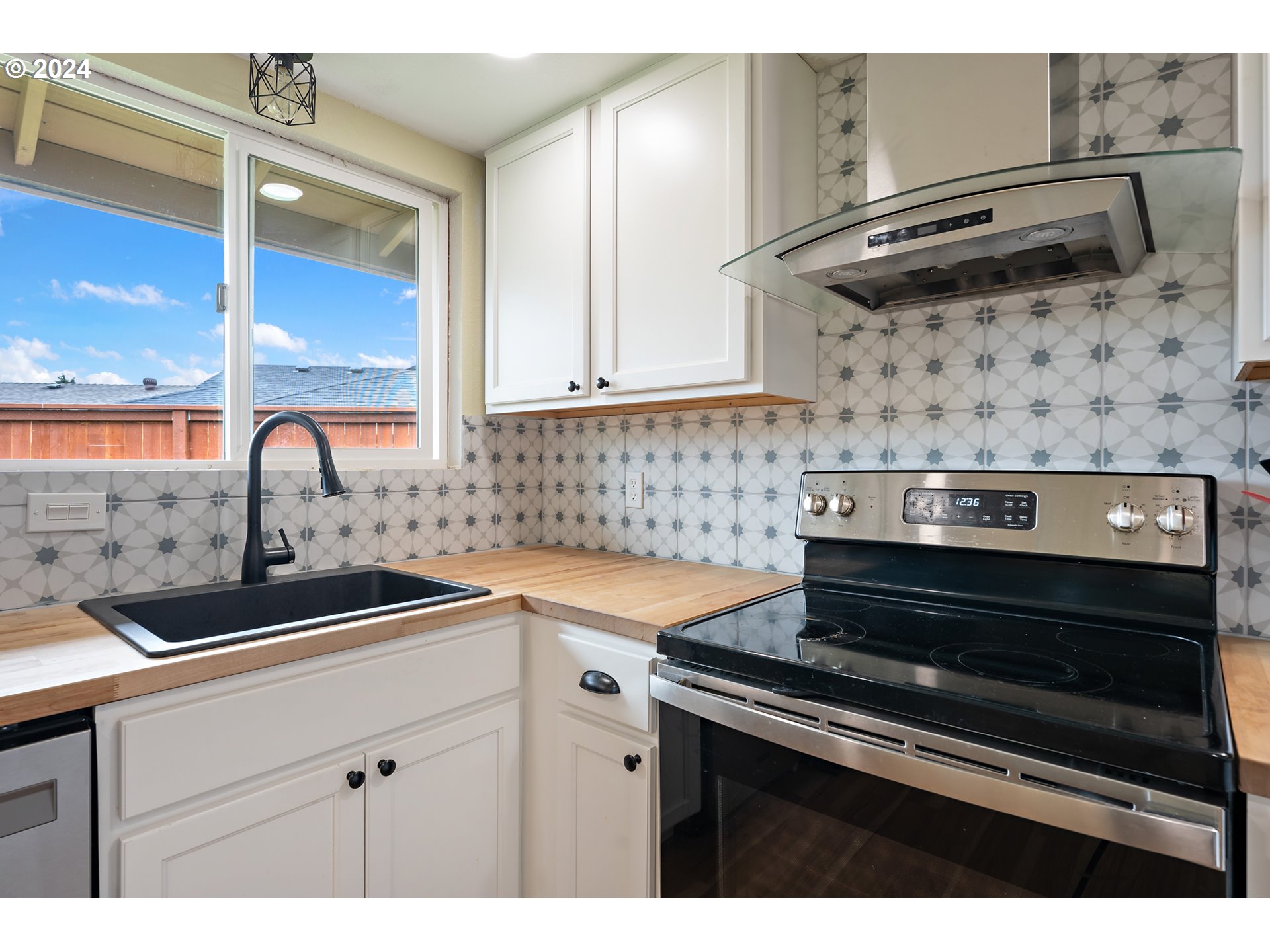 16540 Southwest Queen Mary Avenue Portland, OR 97224 - Photo 16 of 30 a kitchen with a sink stove and cabinets