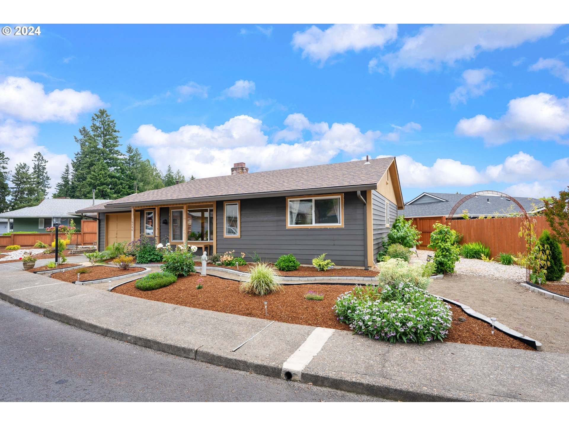 16540 Southwest Queen Mary Avenue Portland, OR 97224 - Photo 3 of 30 a front view of a house with garden