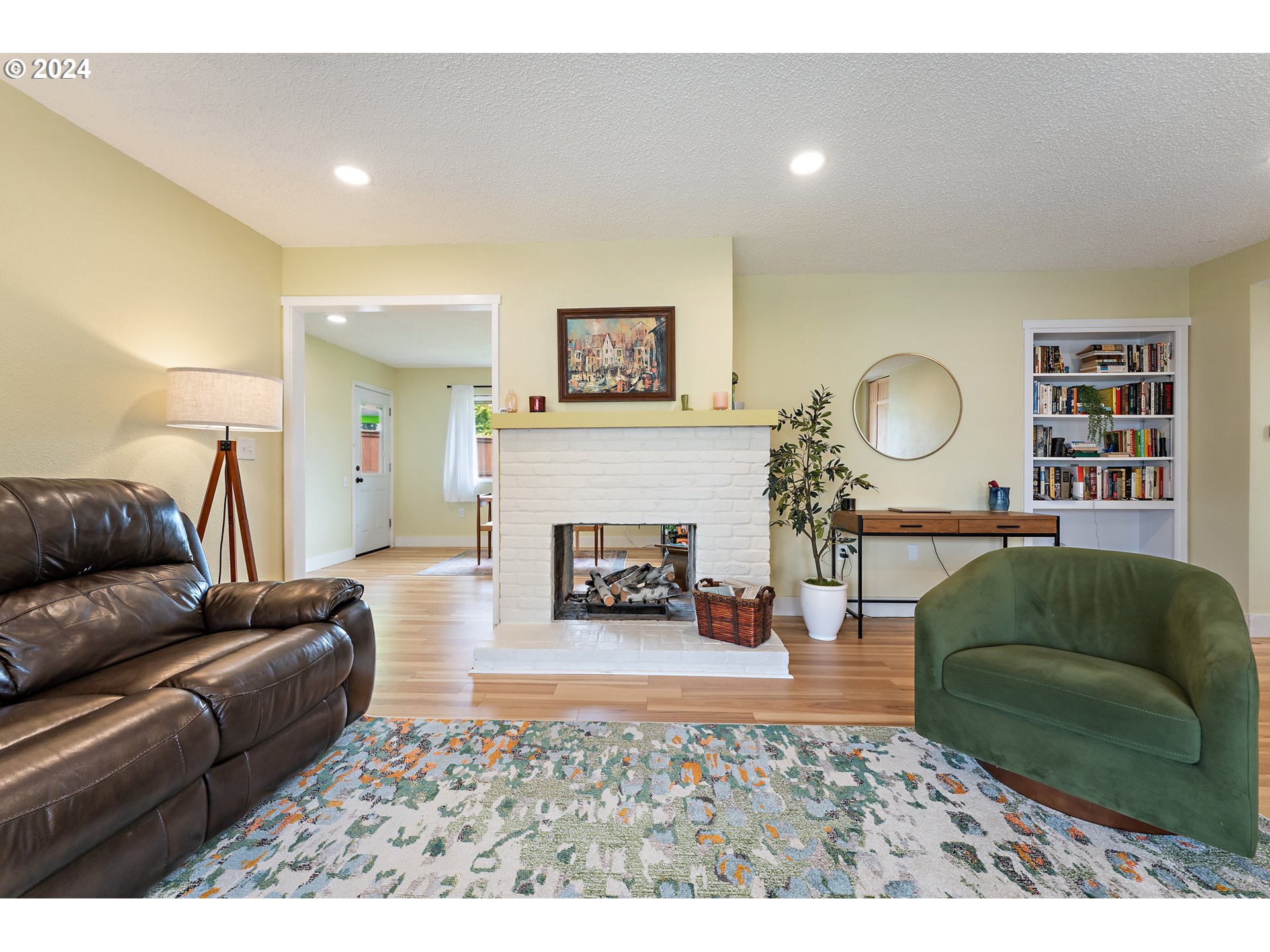 16540 Southwest Queen Mary Avenue Portland, OR 97224 - Photo 7 of 30 a living room with furniture and a fireplace