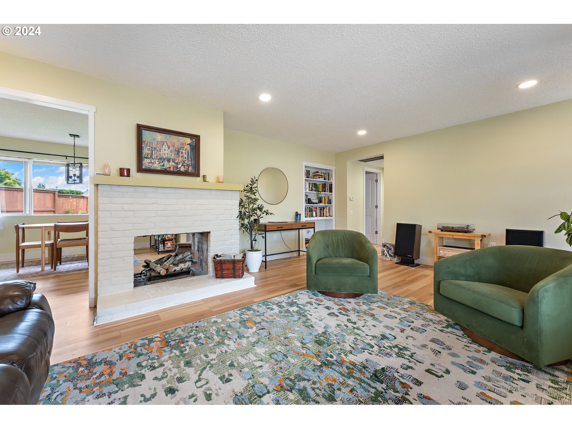 16540 Southwest Queen Mary Avenue Portland, OR 97224 - Photo 8 of 30 a living room with furniture and a fireplace