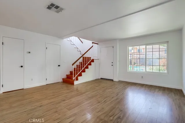 wooden floor in an empty room with a window