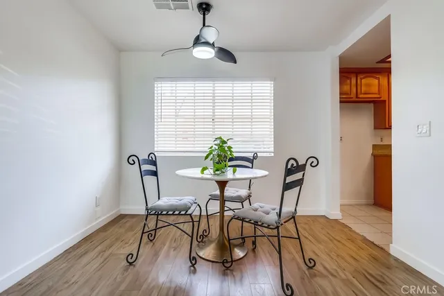 a view of a workspace room with furniture and wooden floor