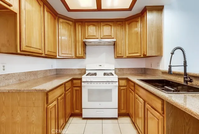 a kitchen with white cabinets and appliances