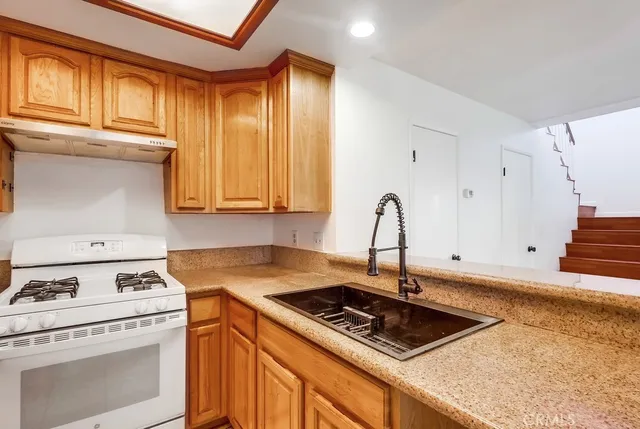 a kitchen with a sink and a window
