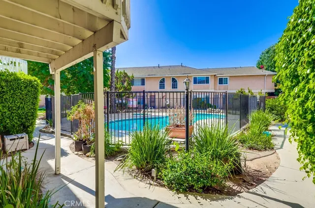 a view of a livingroom with wooden floor and a fireplace