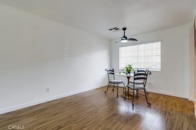 a workspace with wooden floor and a window