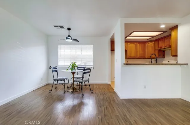 a view of an empty room with wooden floor and stairs