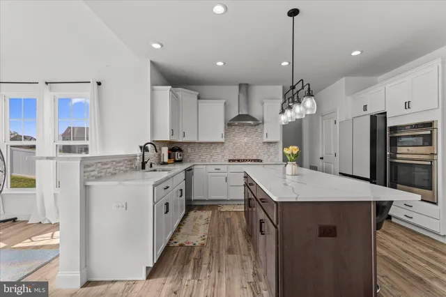 a open kitchen with stainless steel appliances granite countertop a sink stove and refrigerator