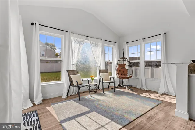 a living room with furniture a air conditioner vent and a window
