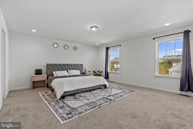 a spacious bedroom with a bed and a window