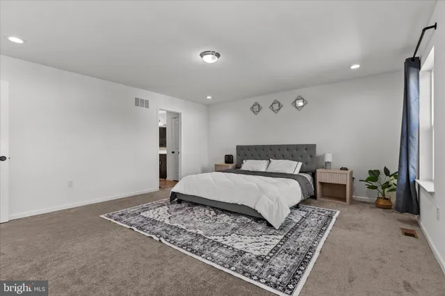 a bedroom with a large bed and a couch