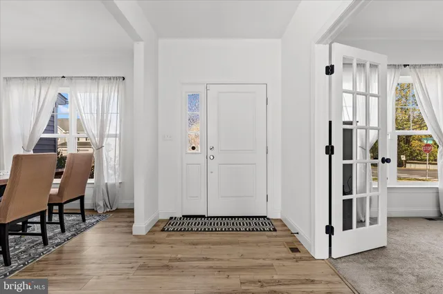 a view of a livingroom with wooden floor and white walls