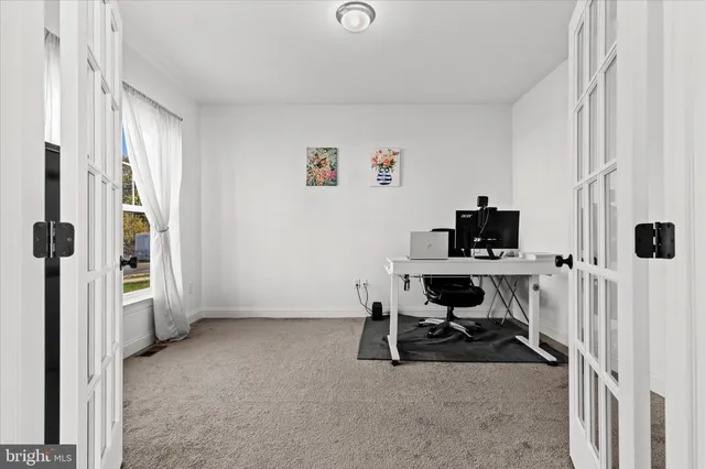 a view of a workspace with a window and shelf