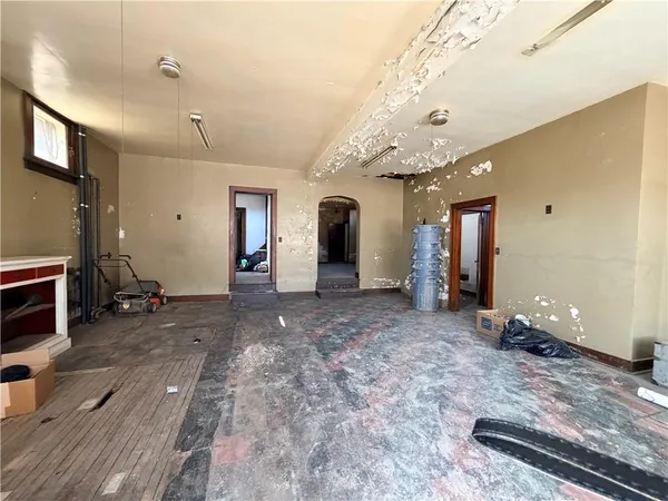 a view of a livingroom with furniture and an empty room