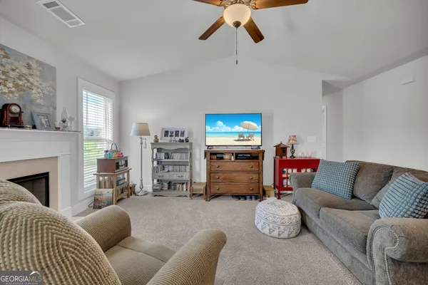 a living room with furniture a window and a fireplace
