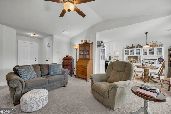 a dining room with furniture a rug and wooden floor