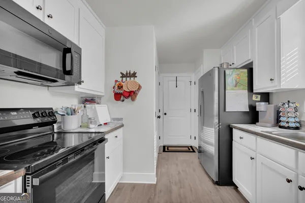 a kitchen with stainless steel appliances granite countertop a stove and a microwave