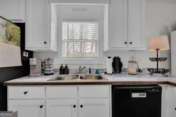 a kitchen with a sink stove top oven and cabinets