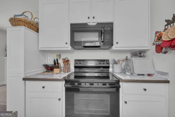 a bathroom with a sink a toilet a mirror and shower curtain