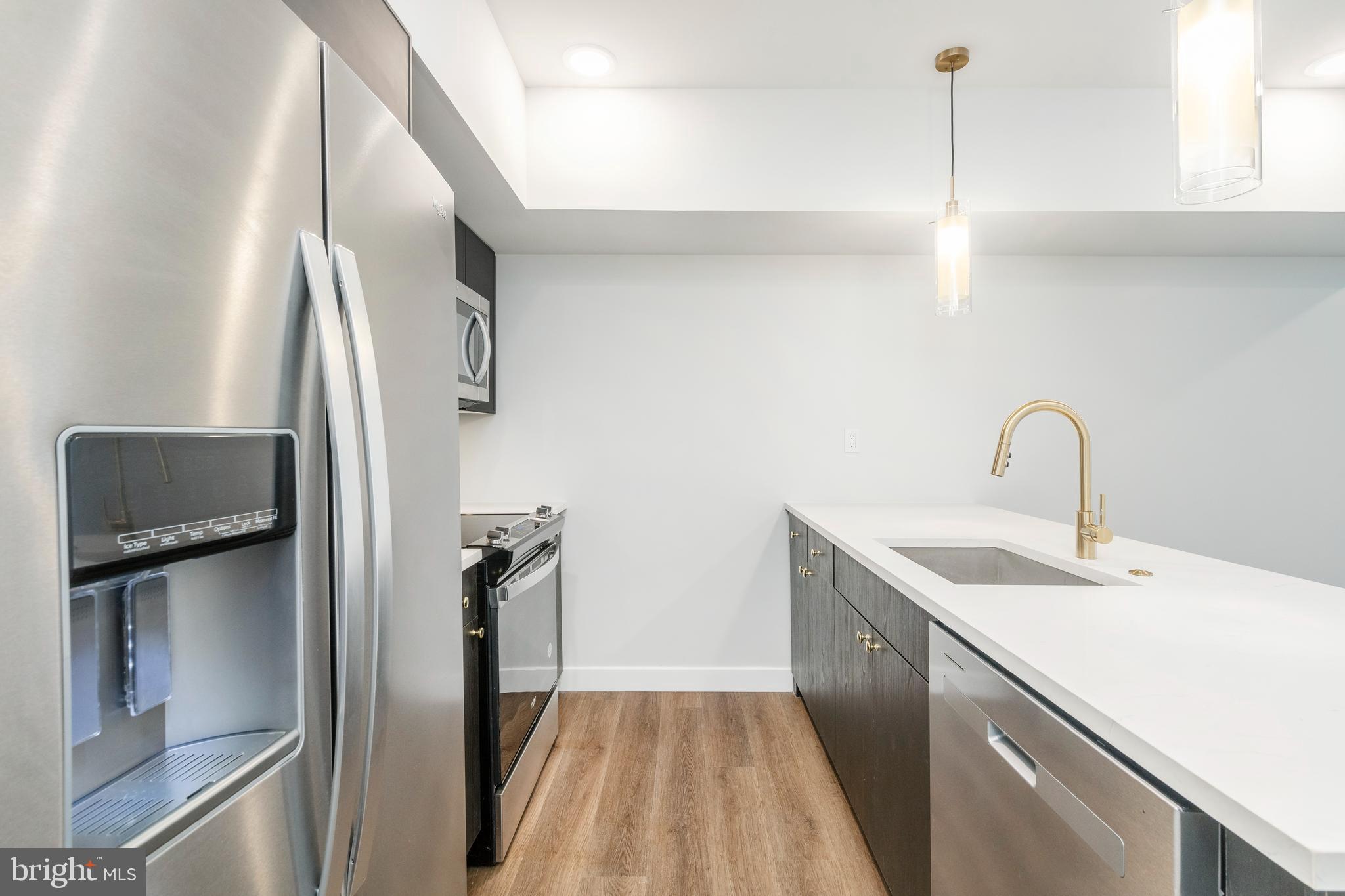 1102 Germantown Avenue, Unit 302 Philadelphia, PA 19123 - Photo 11 of 30 a kitchen with a sink and stainless steel appliances