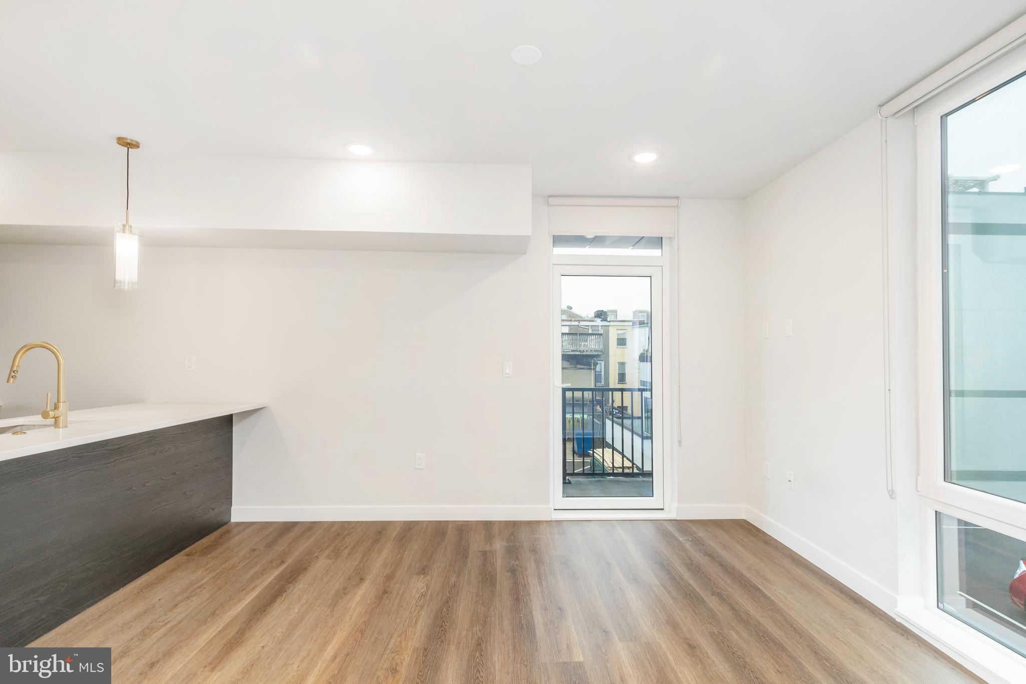 1102 Germantown Avenue, Unit 302 Philadelphia, PA 19123 - Photo 14 of 30 a view of an empty room with wooden floor and a window