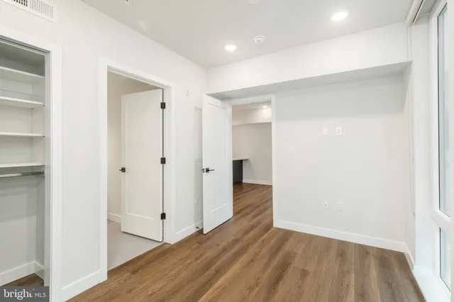 a view of a hallway with wooden floor