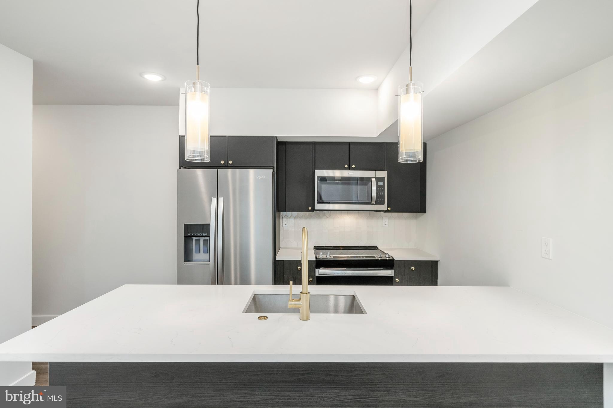 1102 Germantown Avenue, Unit 302 Philadelphia, PA 19123 - Photo 2 of 30 a kitchen with a sink a microwave and cabinets