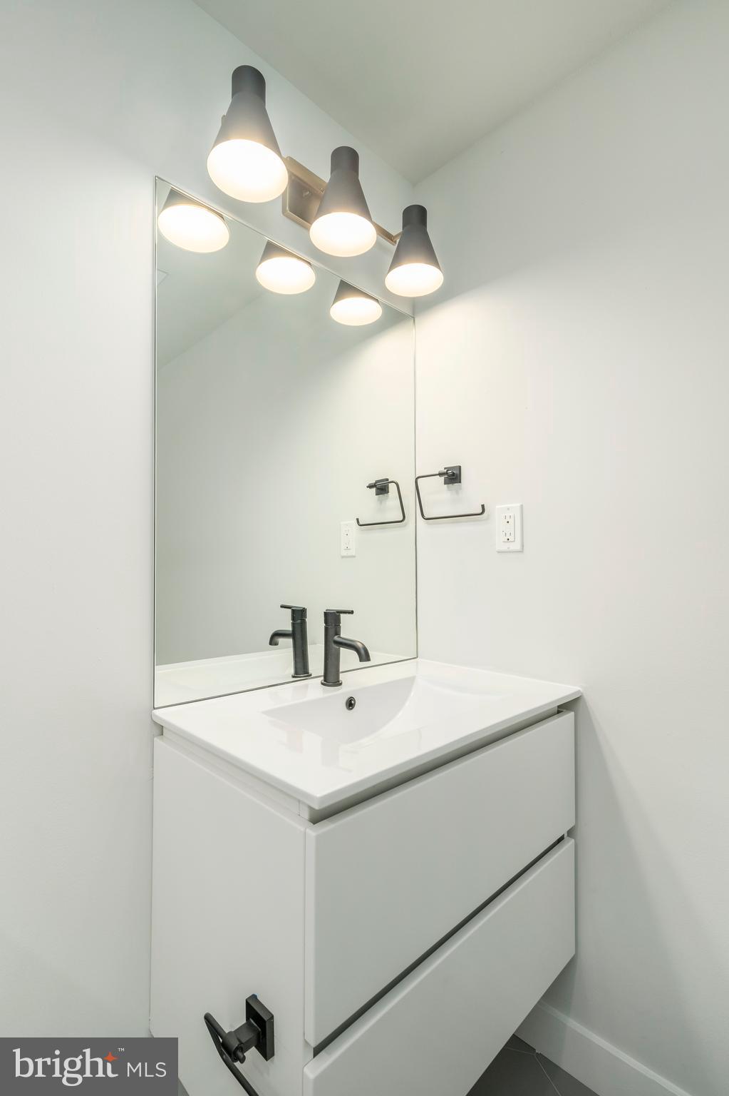 1102 Germantown Avenue, Unit 302 Philadelphia, PA 19123 - Photo 22 of 30 a bathroom with a sink a mirror and vanity